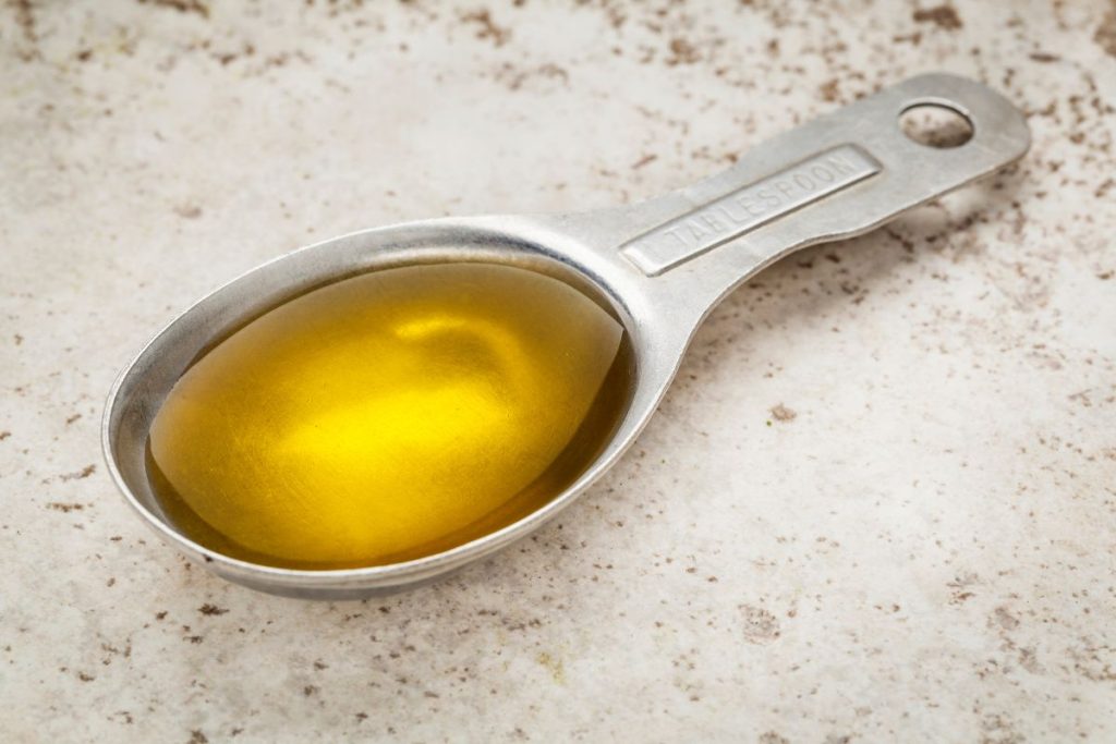 Measuring spoon with fish oil supplement.