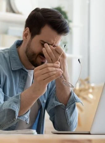 Person-feeling-tired-and-fatigued-at-work showing vitamin d deficiency symptoms